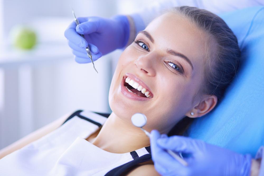 dental bonding dedham | woman smiling at dentist