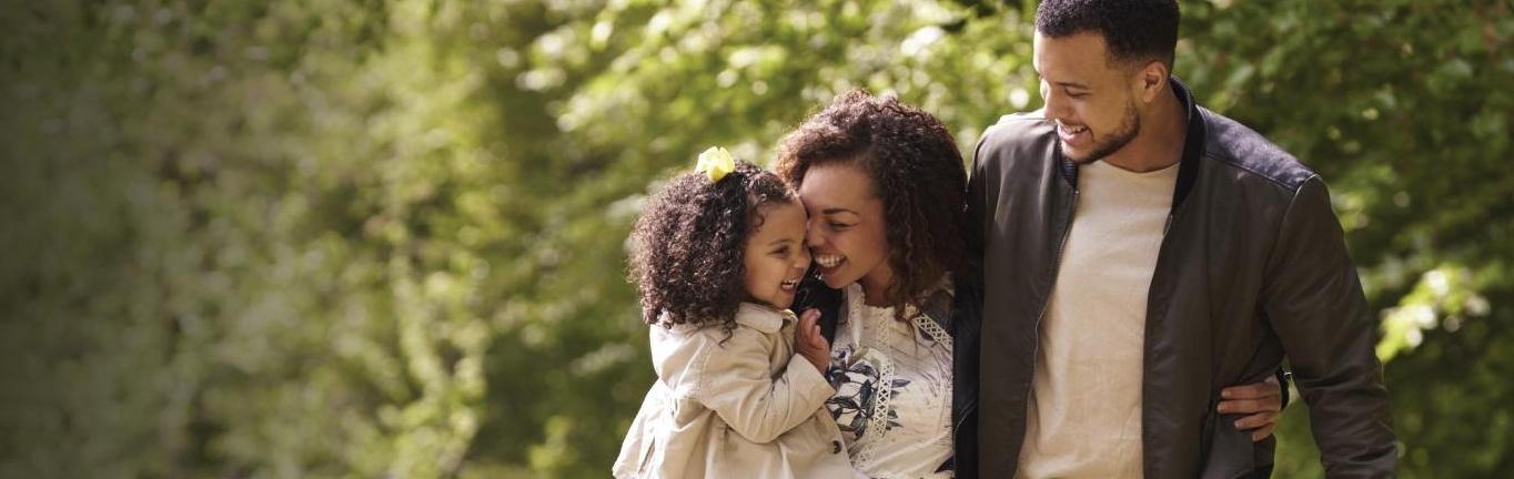 Smiling family in the woods