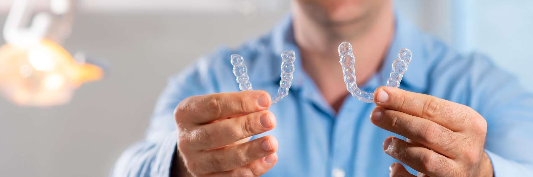 Invisalign dedham | patient holding clear aligners