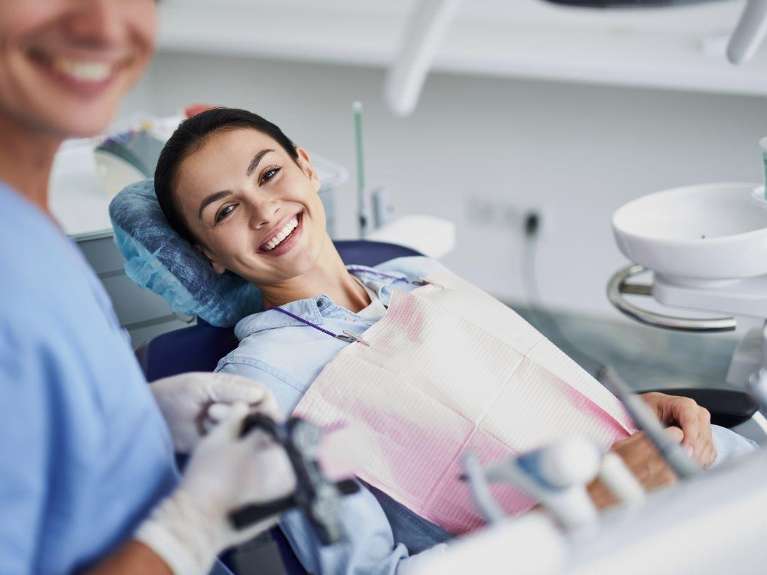 cosmetic dentist dedham | woman smiling at dentist