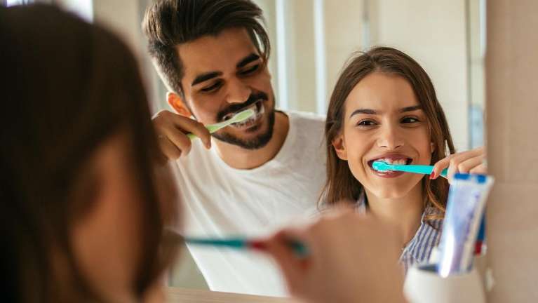 dedham dentist | Couple brushing teeth 