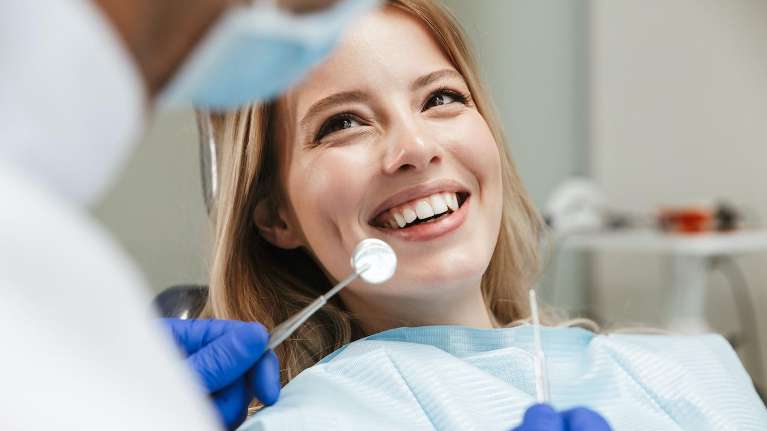 oral health dedham | woman at dentist