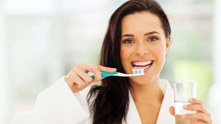 gum disease dedham | woman brushing teeth