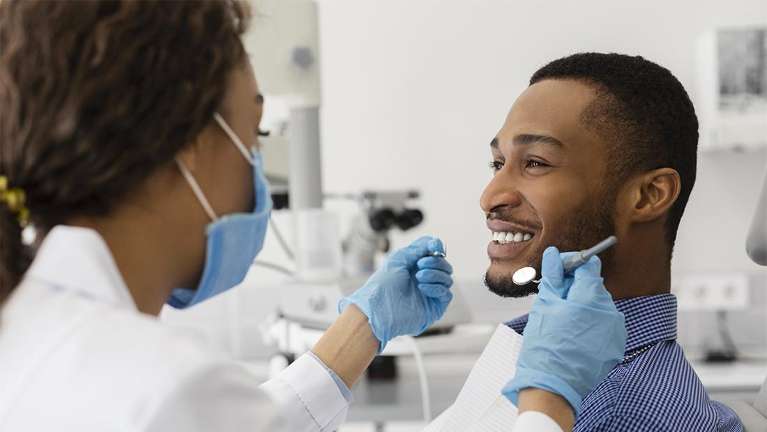 dedham dentist | Man at his dental cleaning