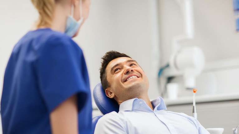 tooth extractions dedham | Man at the dentist