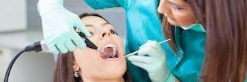 cosmetic dentist norwood | Woman receiving a teeth cleaning